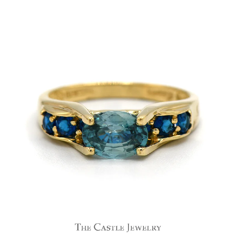 Fashionable Engagement Ring-Oval Blue Zircon Ring with Blue Topaz Sides in 14k Yellow Gold Bridge Designed Mounting